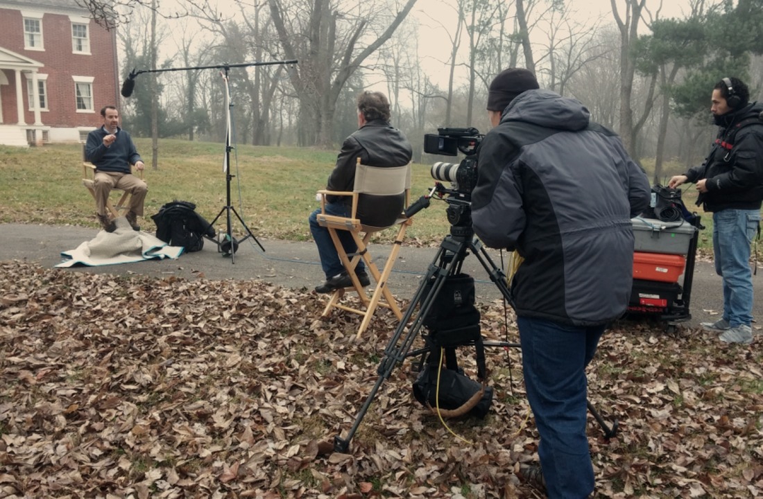 Documentary crew filming an interview outdoors